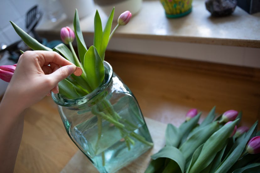 Copper coins added into the water of a flower arrangement act as an anti-bacterial and fungicide, wh...