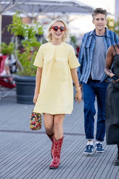 Emma Chamberlain wore a yellow dress, red cowboy boots, and a floral print bag from Gunny Du...