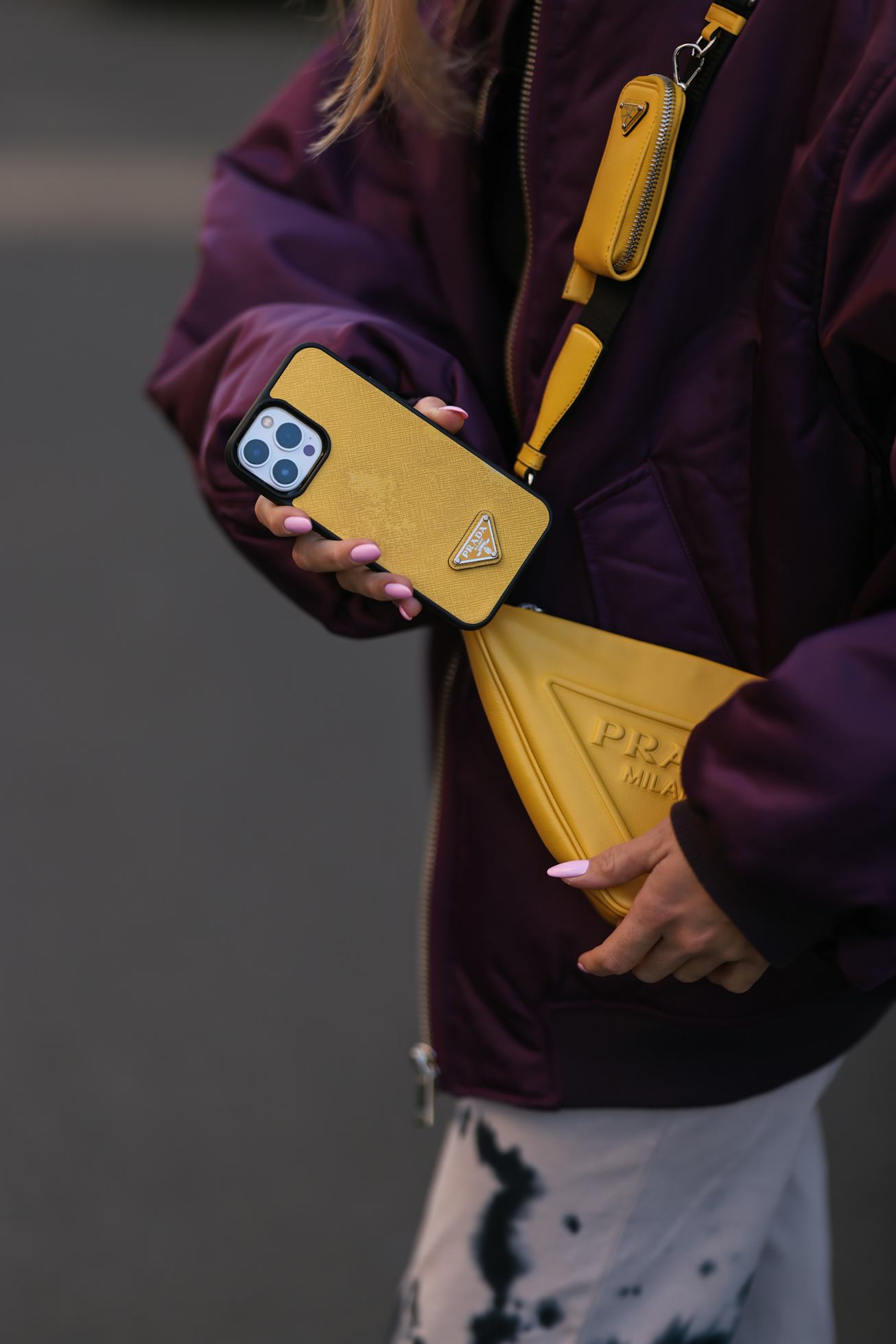 BERLIN, GERMANY - MARCH 24: Sonia Lyson seen wearing a yellow Prada iPhone case, Prada yellow triang...