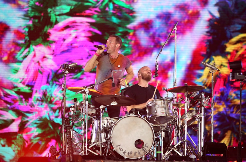 Chris Martin and Will Champion of Coldplay perform at Wembley Stadium on August 12, 2022 in London, ...