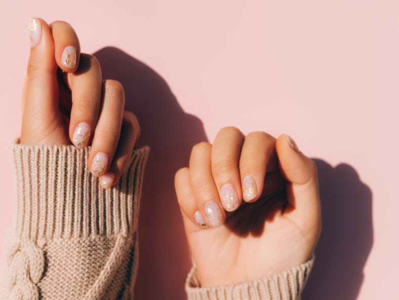 Fall 2022 nail trends include short oval nail shapes, one of fall 2022's nail art trends.