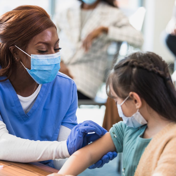 Nurse prepares injection site for COVID booster. The White House expects an updated booster to prote...