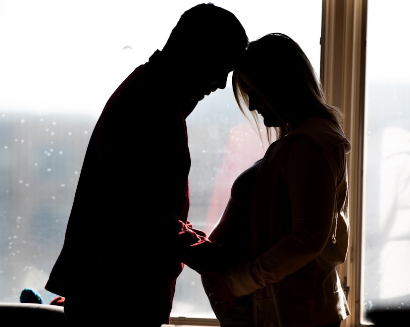 Mother and Father of identical twins are in hospital together preparing for birth