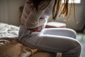 Stomach Ache Experienced By Female Getting Out Of Bed