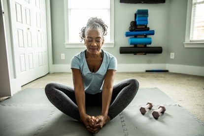 Senior woman exercising in home gym in an article about why grandparents might not help with grandki...