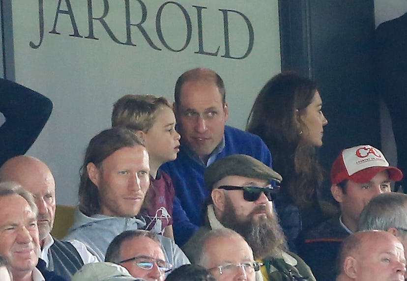 Prince William discusses soccer with Prince George.