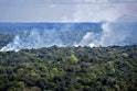 Aerial view showing smoke from a fire billowing from the Amazon rainforest in Oiapoque, Amapa state,...