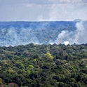 Aerial view showing smoke from a fire billowing from the Amazon rainforest in Oiapoque, Amapa state,...