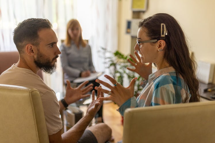 Couple arguing during therapy session with psychologist in the office