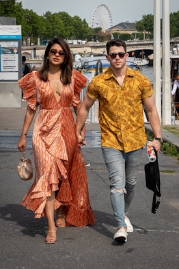 Priyanka Chopra and husband Nick Jonas, wearing matching outfits, are seen as they disembarked from ...