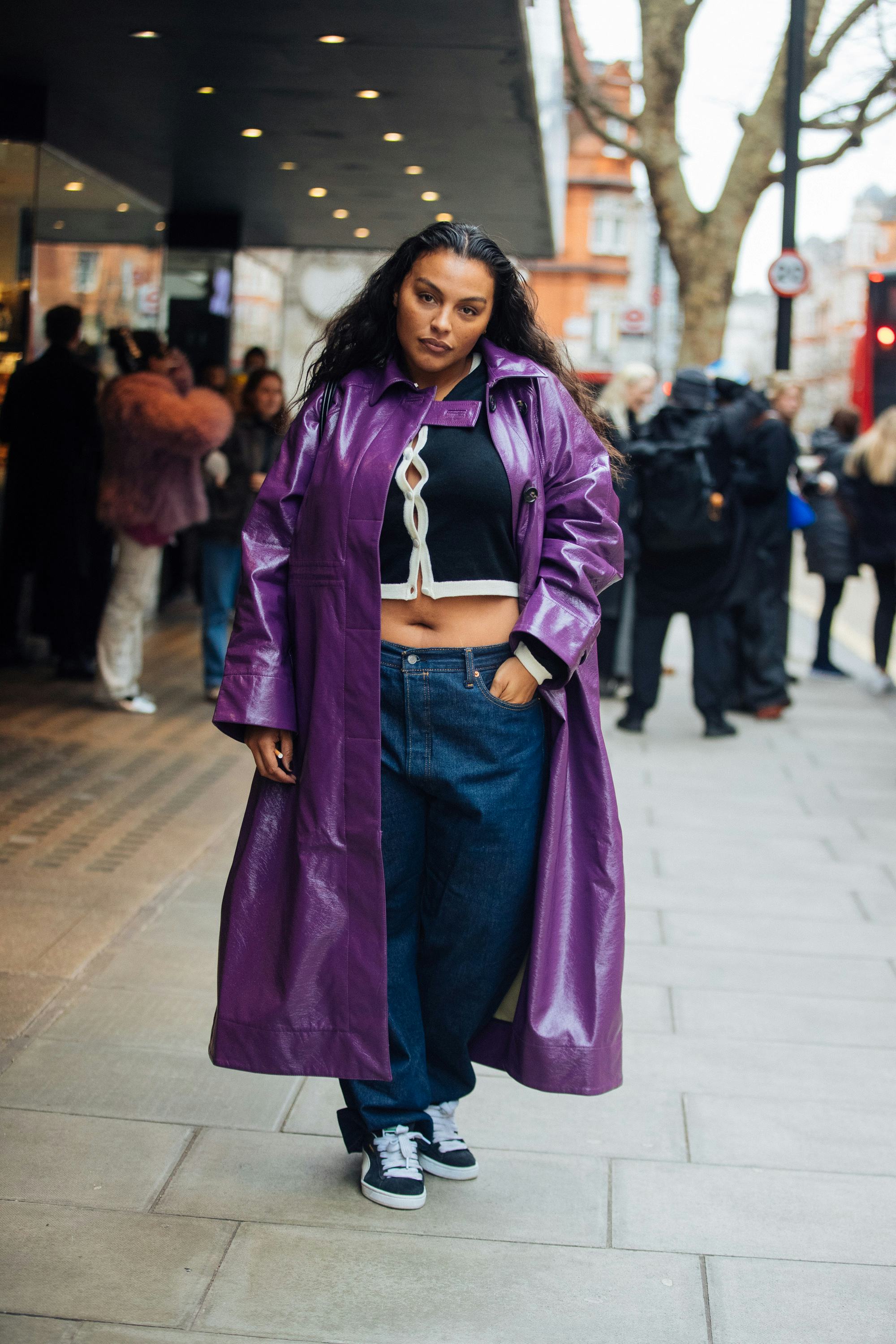 Paloma Elsesser wears a purple leather trench coat, black cropped cardigan, blue jeans, and black Pu&hellip;
