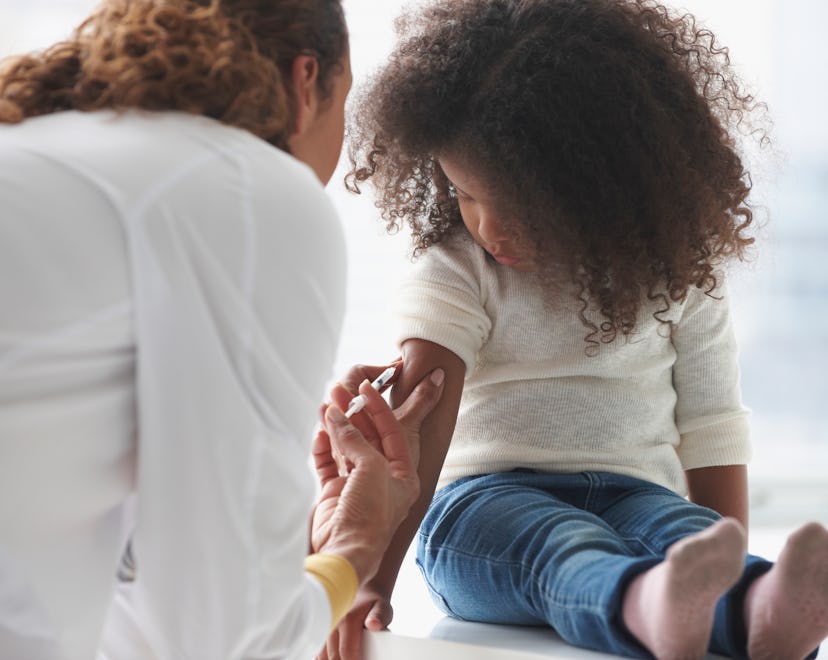 A little girl getting the Polio vaccine at a doctor's office