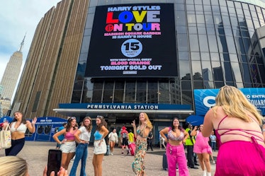 Fans in themed outfits to photos outside Madison Square Garden before Harry Styles' 'Love On Tour' 2...