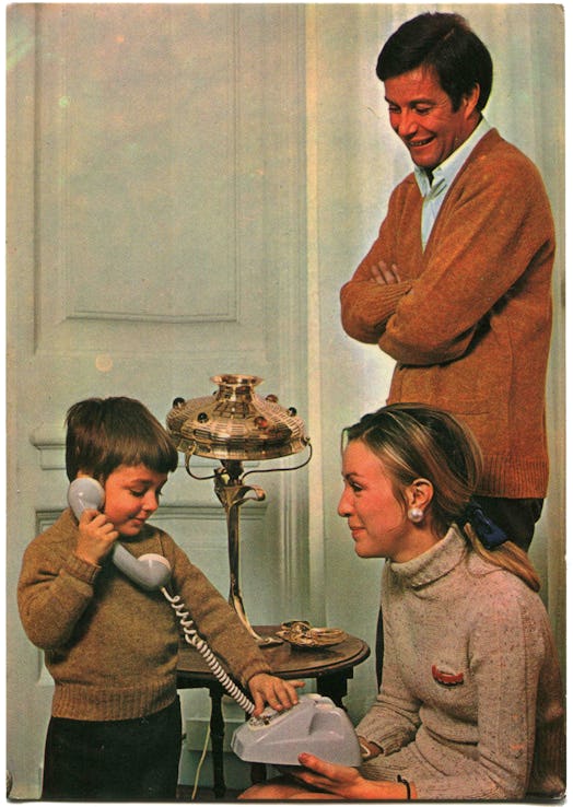 Postcard printed in Portugal shows happy parents are watching a boy who talking on the phone, Portug...