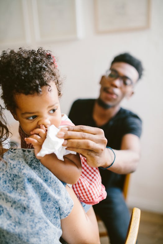 dad wiping baby's spit up 