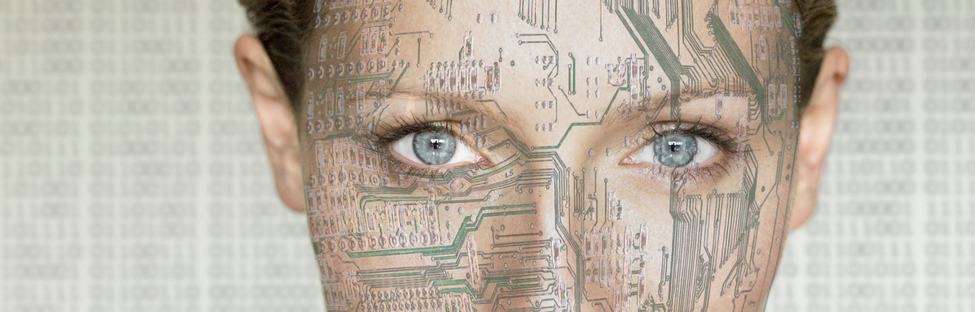Portrait of woman with computer circuit board lines on face and neck , digital composite