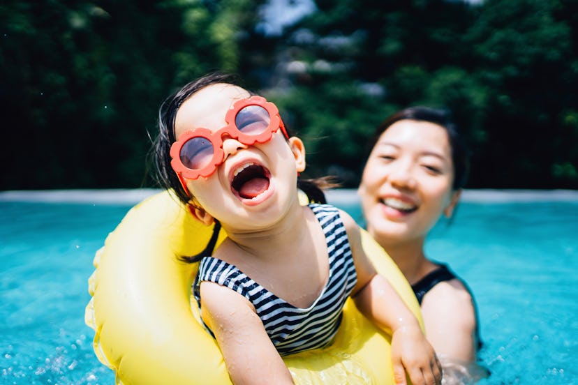 Happy Asian toddler girl with sunglasses smiling joyfully in an article about Disney girl names
