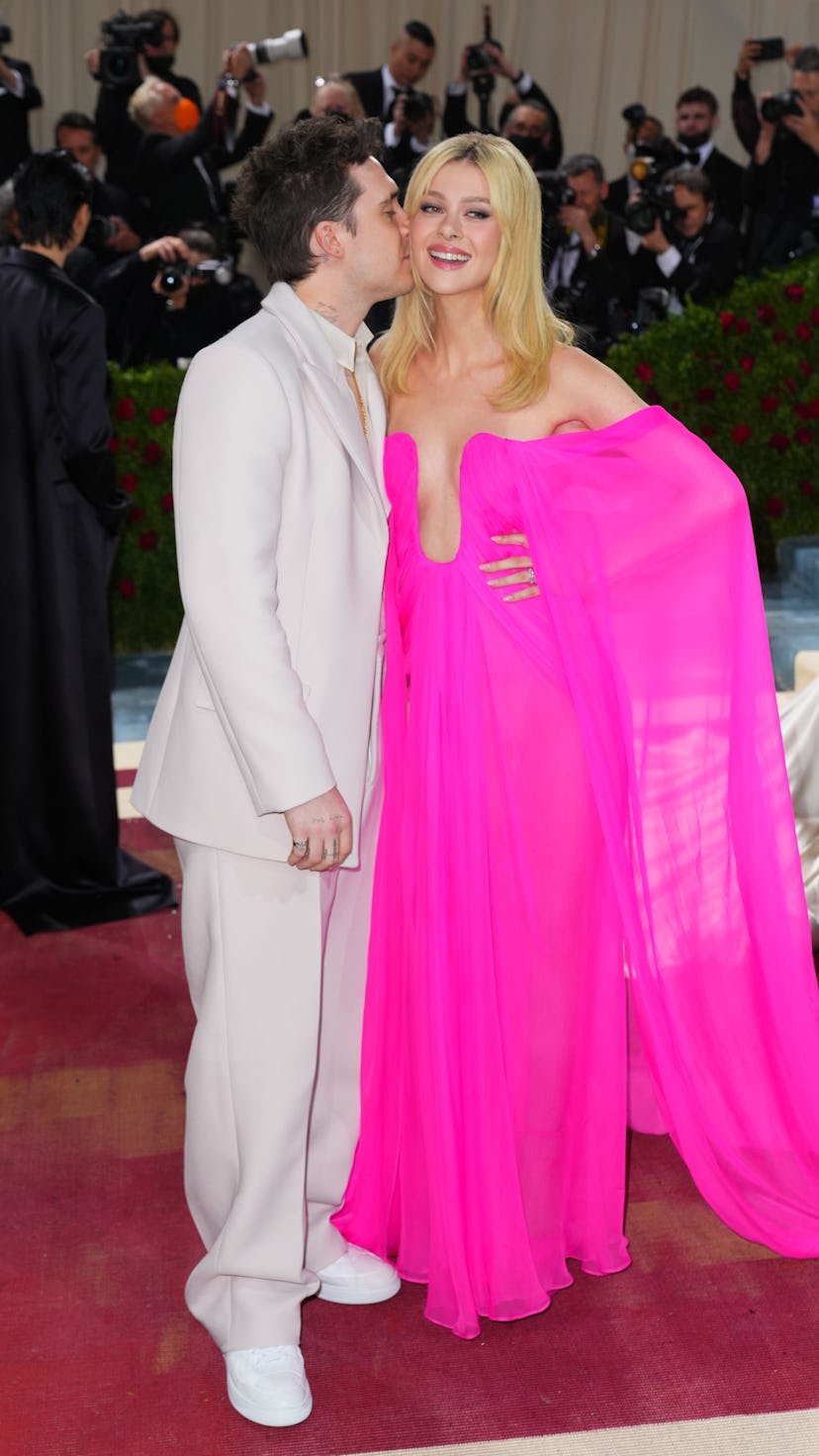 Nicola Peltz's post-wedding style includes bright colors as seen in this pink draped gown, at the 20...
