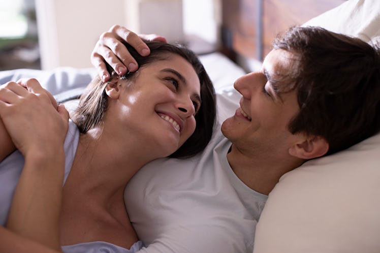 Young couple romancing in the bedroom