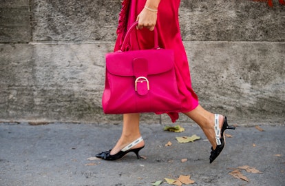 PARIS, FRANCE - SEPTEMBER 28: A guest is seen wearing pink bag, wrapped skirt outside Haider Ackerma...