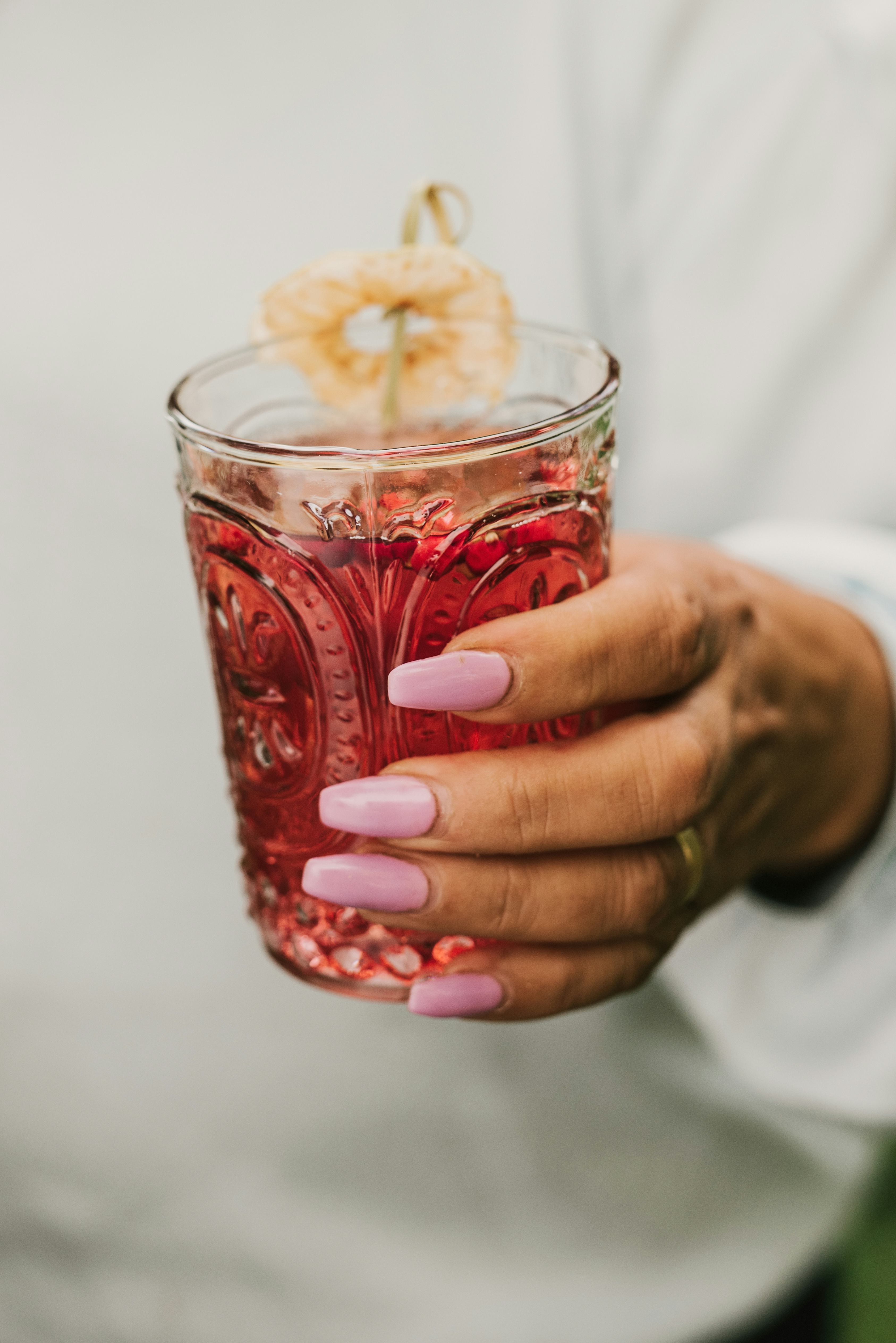 Aperitif red drink with dried apple 
Woman holding tray with snacks and drinks
Photo taken in autumn...