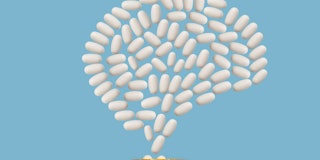 White pills emerging from prescription pill bottle forming shape of human brain, blue background