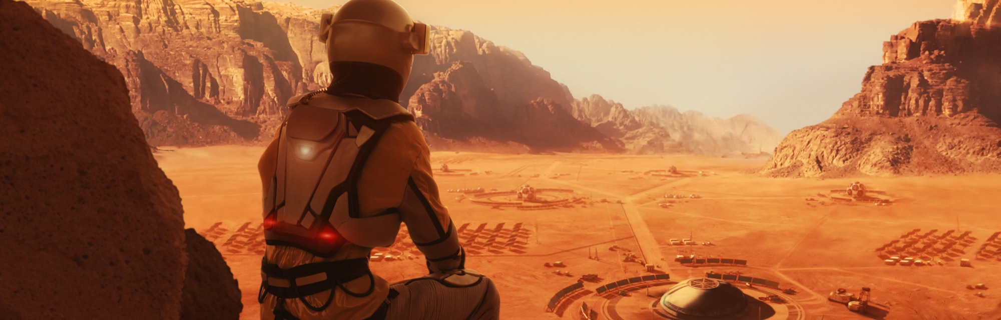 Sitting alone and looking at a Mars space outpost or an alien colony in arid red desert. NASA Public...