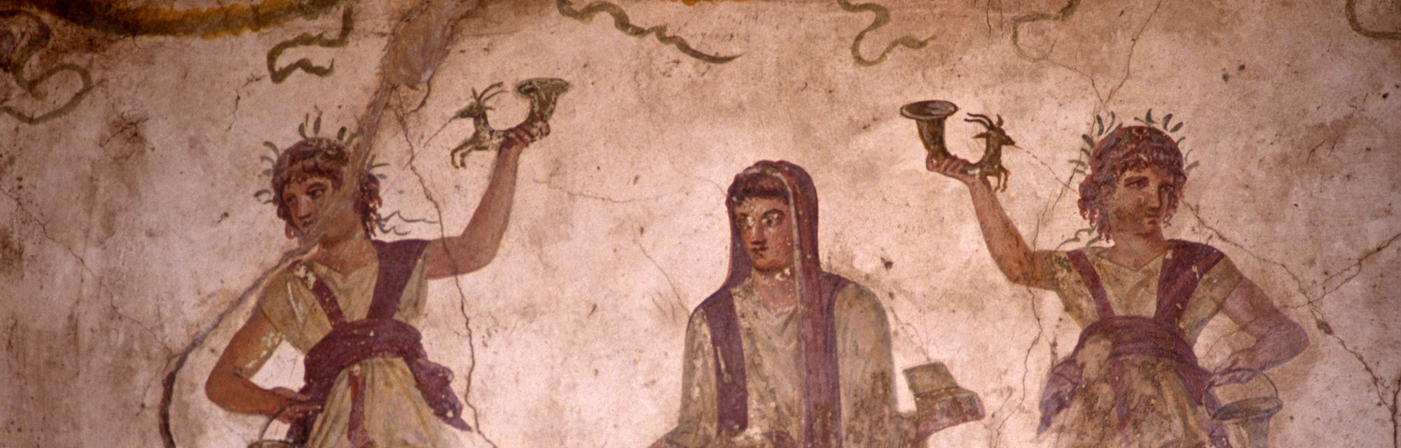 In the Villa of the Vettii in Pompeii we see a fresco in the lararium where a shrine to Roman guardi...