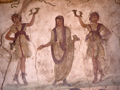 In the Villa of the Vettii in Pompeii we see a fresco in the lararium where a shrine to Roman guardi...