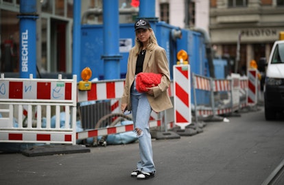 BERLIN, GERMANY - SEPTEMBER 24: Sonia Lyson wearing Chanel sandals and bag, Prada hat, Cos beige bla...