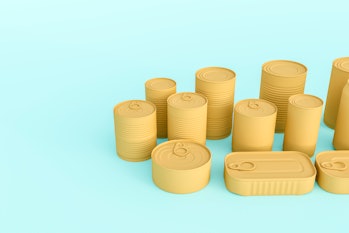 Different tins of food isolated on green background