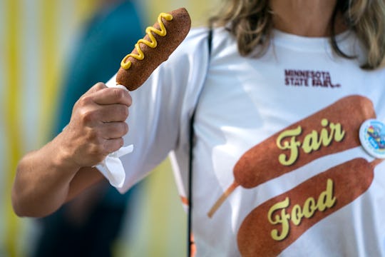 FALCON HEIGHTS, MN - AUGUST 22: A corndog fan posed with a meal that matched her shirt during the fi...