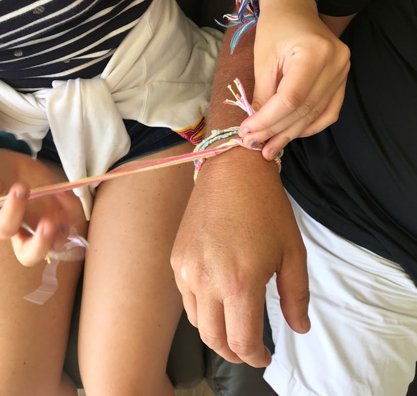 A Gen Z couple wearing matching long-distance relationship bracelets to show they care.