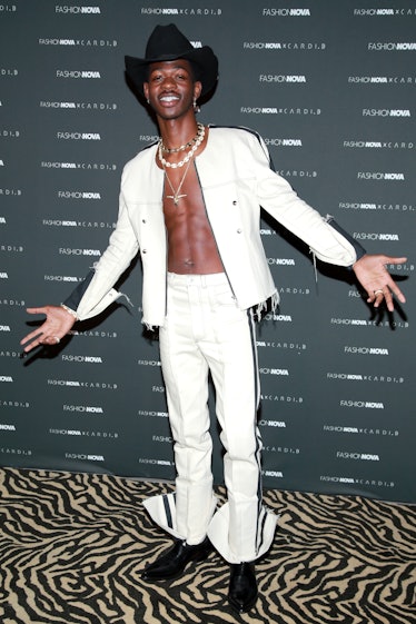 Lil Nas X Style Evolution: the rapper wore a white denim suit to the Fashion Nova x Cardi B Collecti...