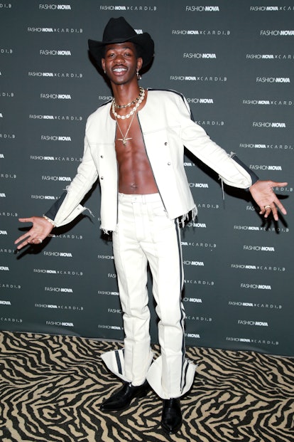 Lil Nas X Style Evolution: the rapper wore a white denim suit to the Fashion Nova x Cardi B Collecti...
