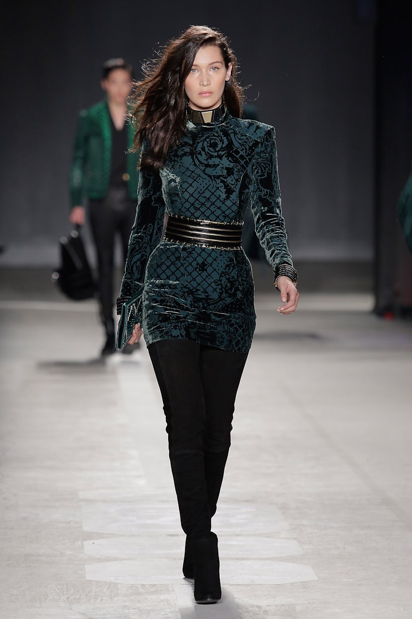 Bella Hadid walks the runway wearing the BALMAIN X H&M collection 
