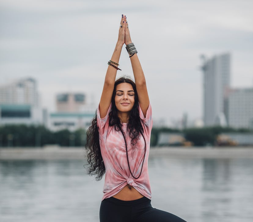 A woman does a 10 minute yoga routine with yoga poses. 