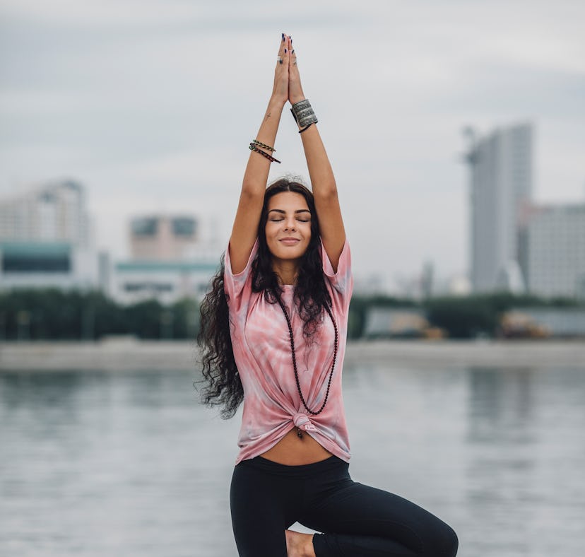 A woman does a 10 minute yoga routine with yoga poses.