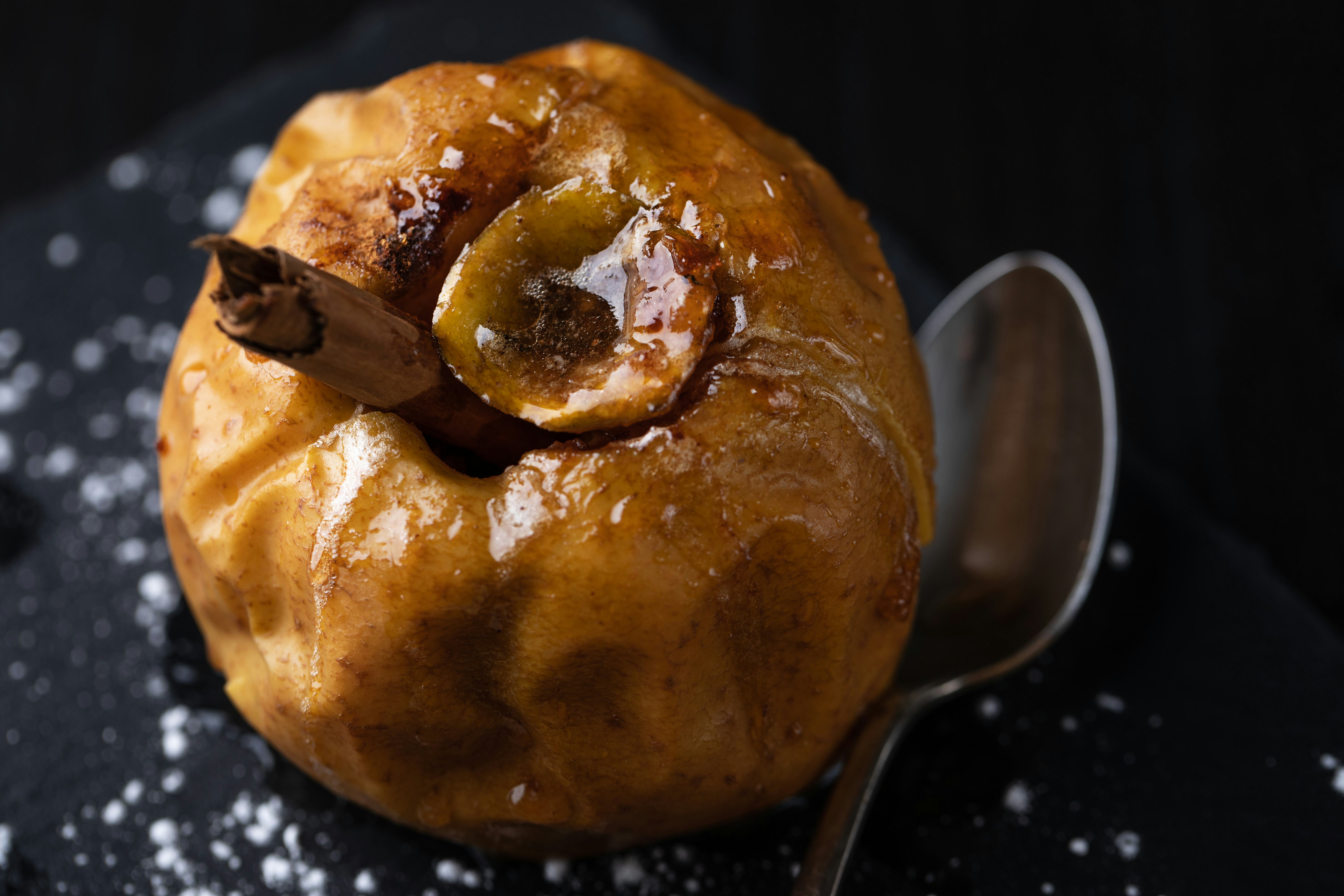 Close up of baked apple stuffed with butter, cinnamon and sugar
