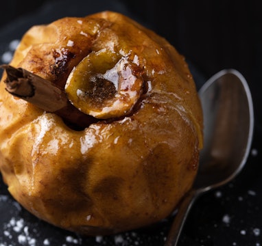 Close up of baked apple stuffed with butter, cinnamon and sugar