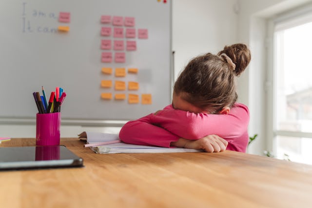 A schoolgirl with her head down on a desk. A Missouri school is reinstating paddling as punishment.