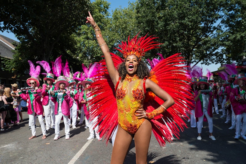 LONDON, UNITED KINGDOM - AUGUST 26: Samba performers in colourful costumes dance to the rhythms of t...