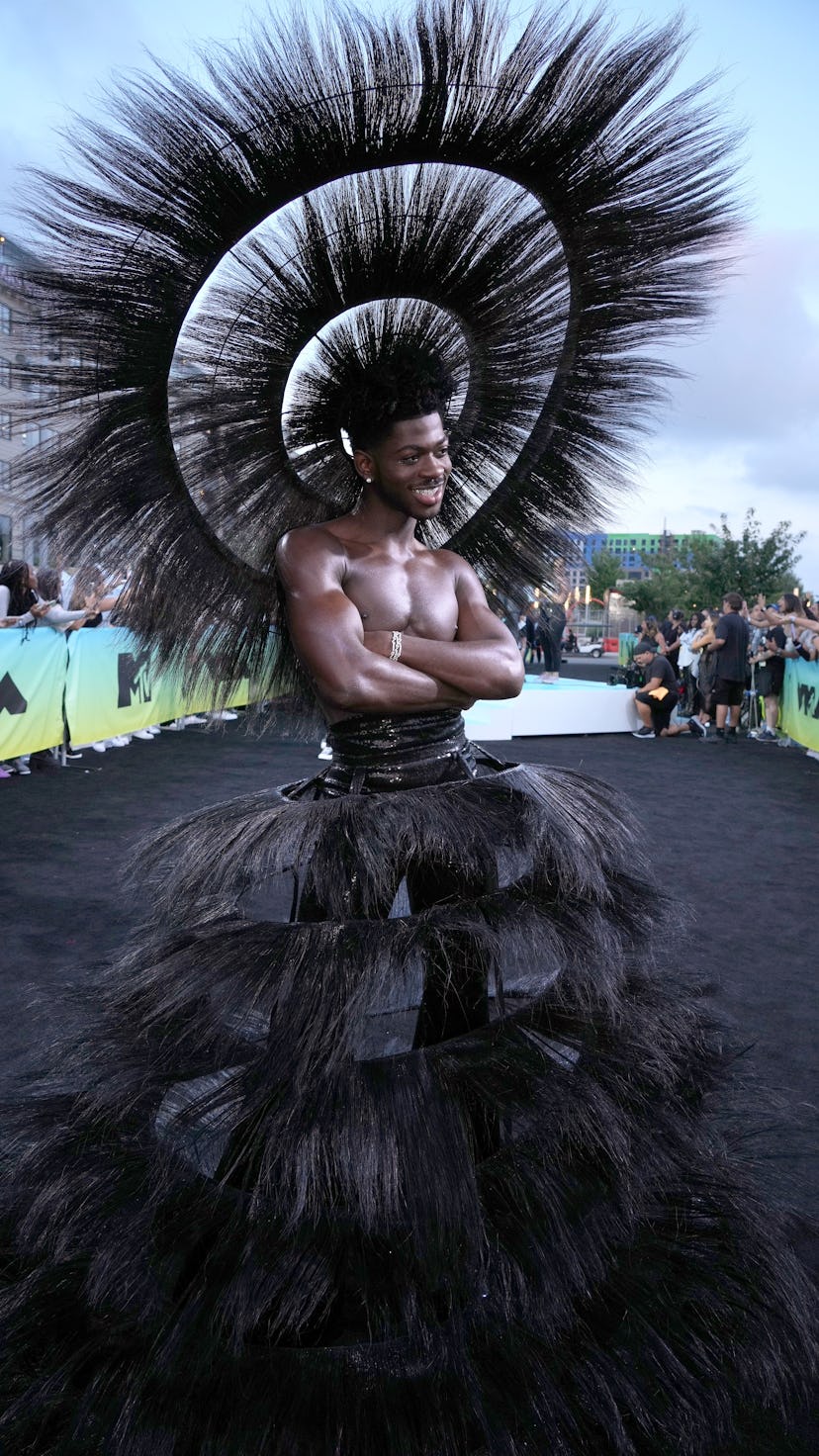 Lil Nas X's 2022 MTV VMAs outfit included a feathered hat and skirt to the 2022 MTV VMAs on August 2...
