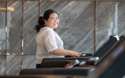 Fat Asian woman exercising on a treadmill in a gym, exercise concept, weight loss