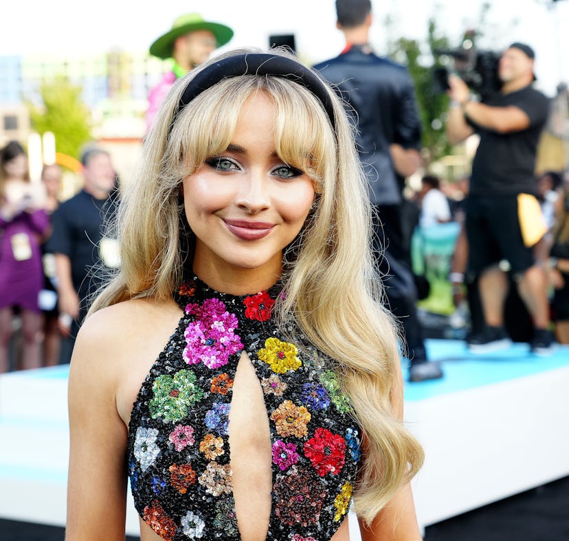 Sabrina Carpenter wears a gown with cut outs to the 2022 MTV VMAs at Prudential Center on August 28,...