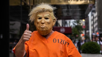 A protestor dressed up as former US President Donald Trump poses for photos outside Trump Tower in N...