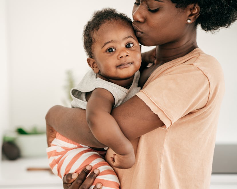 Baby and mom snuggling in an article about how long does a cold last in a baby?