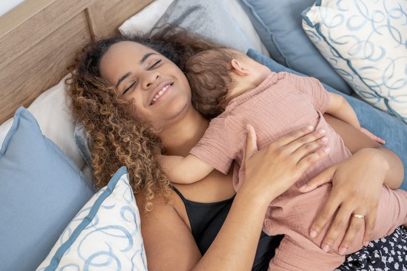 Newborn baby asleep on mother's chest. post a breastfeeding caption on Instagram