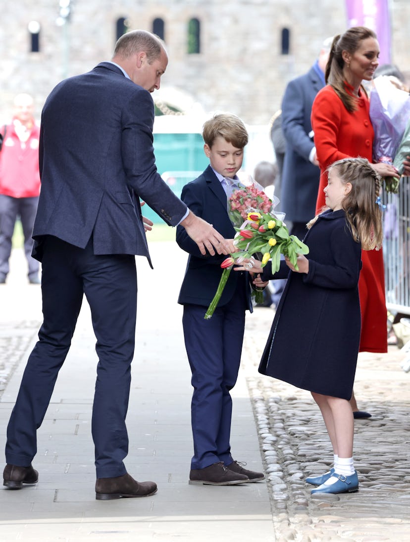 Prince William gives his daughter flowers.