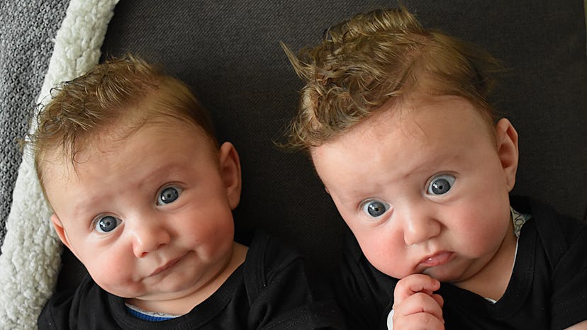 twin babies with their heads close together in an article about the best instagram captions for pict...